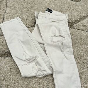 White Hollister boyfriend jeans with lots of holes